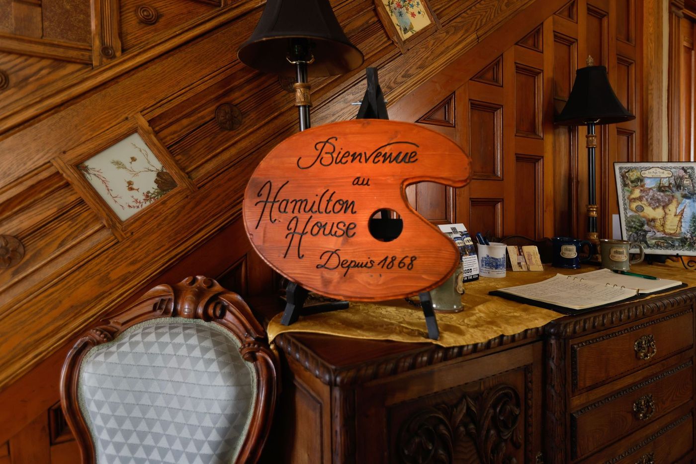 a wooden sign on a table that says hamilton house