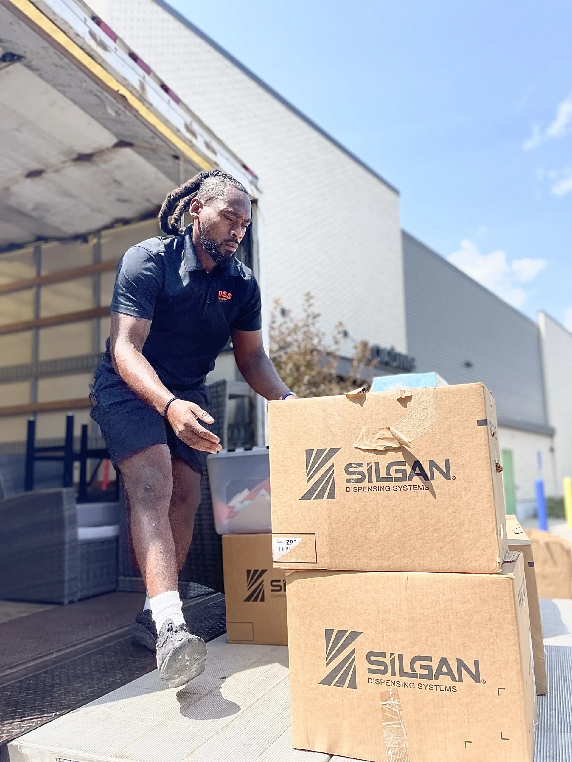 Man unloading boxes labeled Man unloading boxes labeled