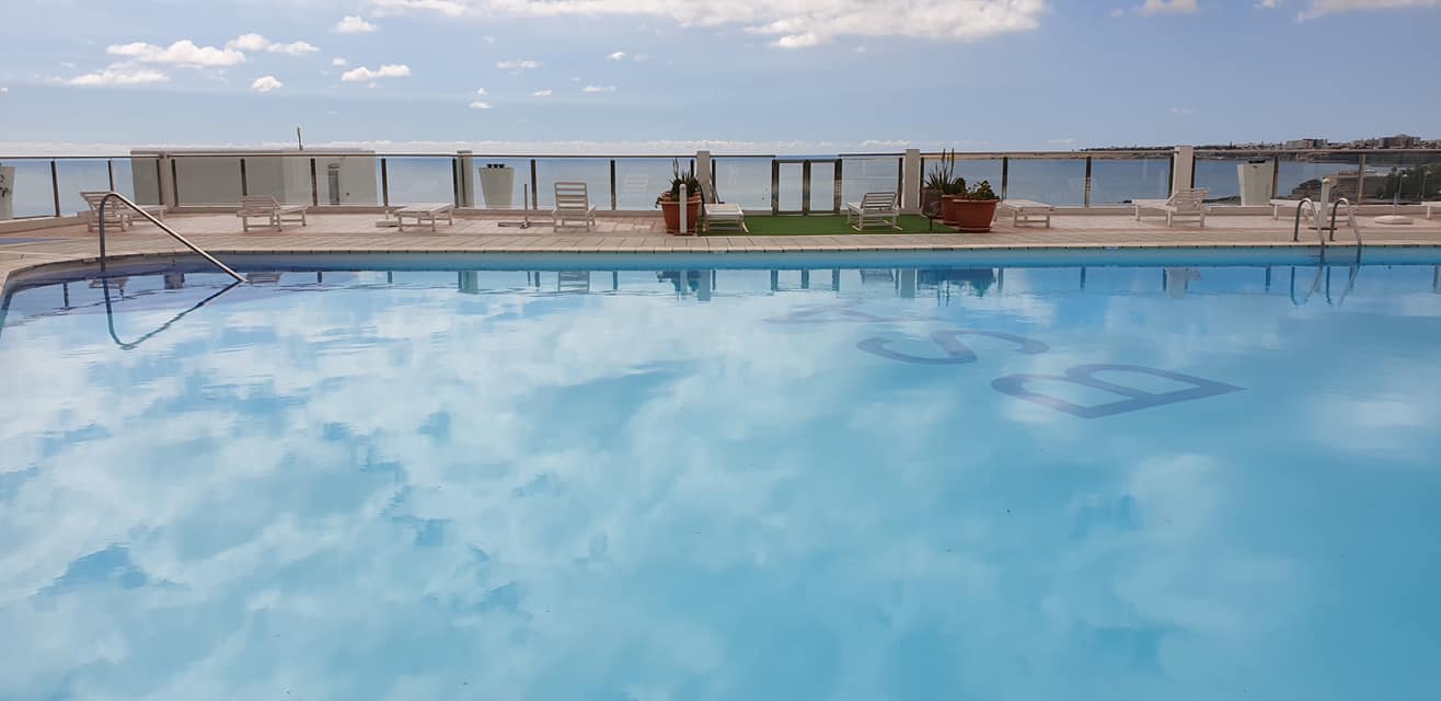 Ein großer Swimmingpool mit Blick auf das Meer.