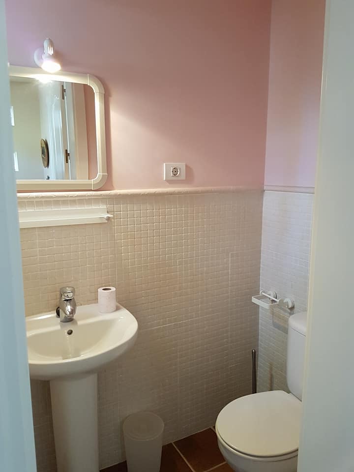 Ein Badezimmer mit Waschbecken, Toilette und Spiegel