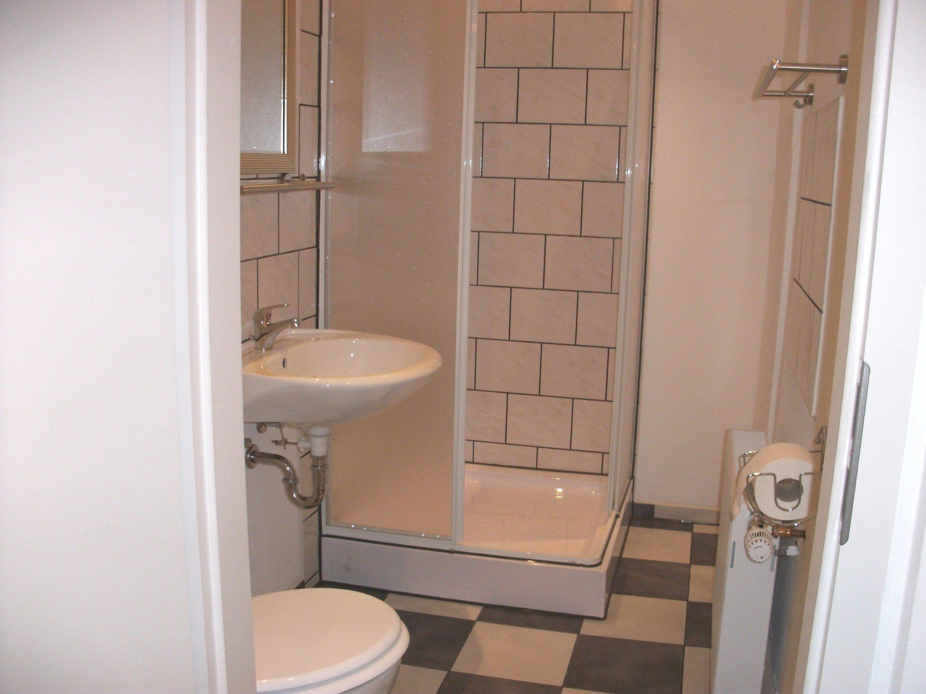 Ein Badezimmer mit Toilette, Waschbecken und Dusche