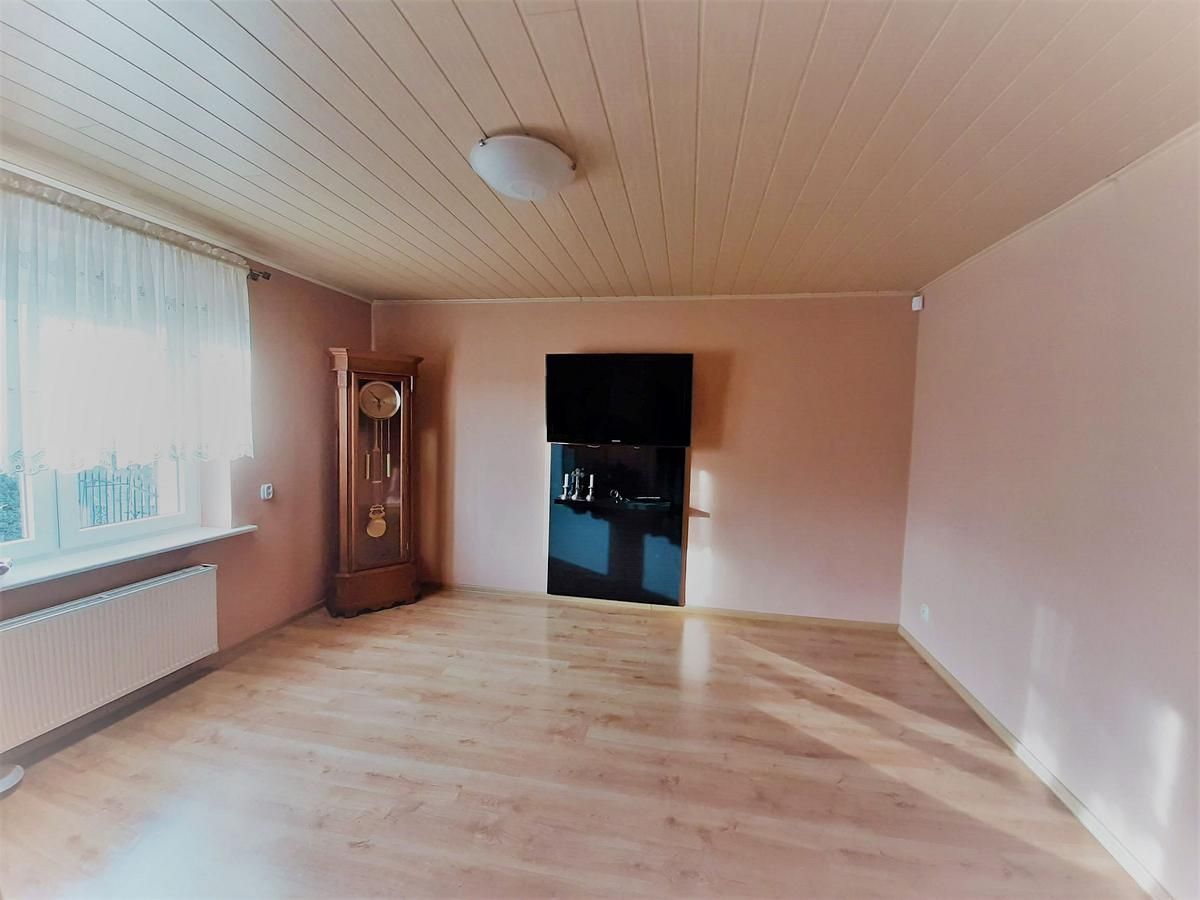 Ein Wohnzimmer mit einem Flachbildfernseher an der Wand