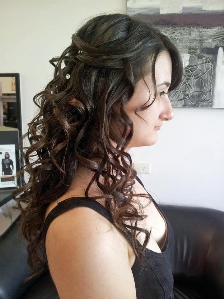 A Woman With Long Curly Hair is Wearing a Black Tank Top — Xquisite Styles in Albion Park, NSW