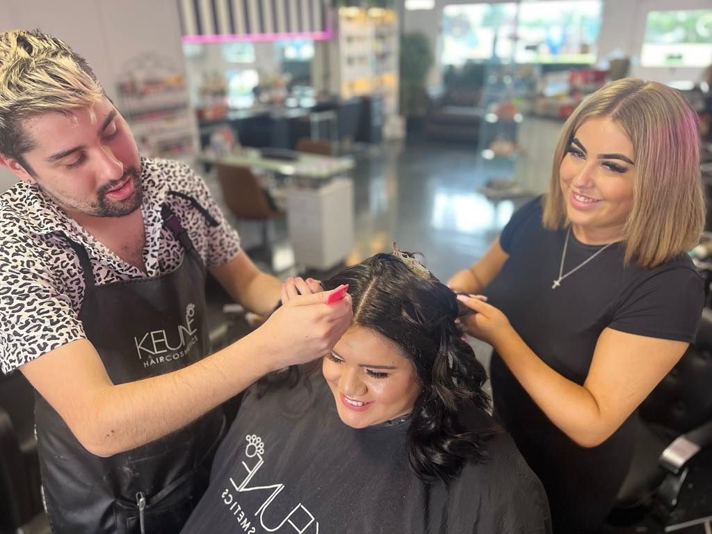 A Man is Cutting a Woman 's Hair in a Salon — Xquisite Styles in Albion Park, NSW