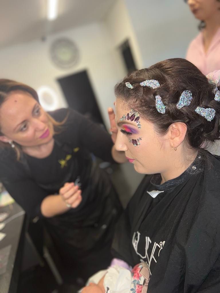 A Woman is Getting Her Hair Done by a Hairdresser in a Salon — Xquisite Styles in Mount Warrigal, NSW