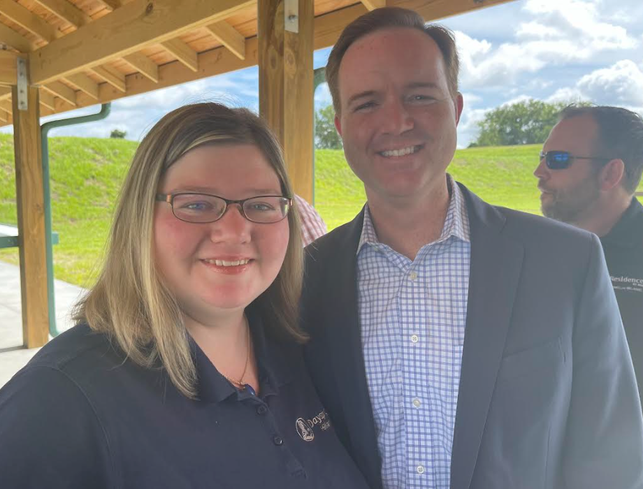 A man and a woman are posing for a picture under a canopy.