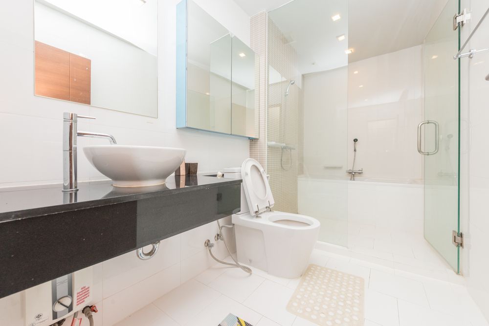 A Modern White Bathroom with Floating Vanity — Professional Plumber in Toowoomba