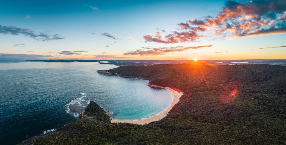 Aerial view showcasing the captivating beauty of the forest and the nearby sea — Stan Davies Excavations in Maitland, NSW