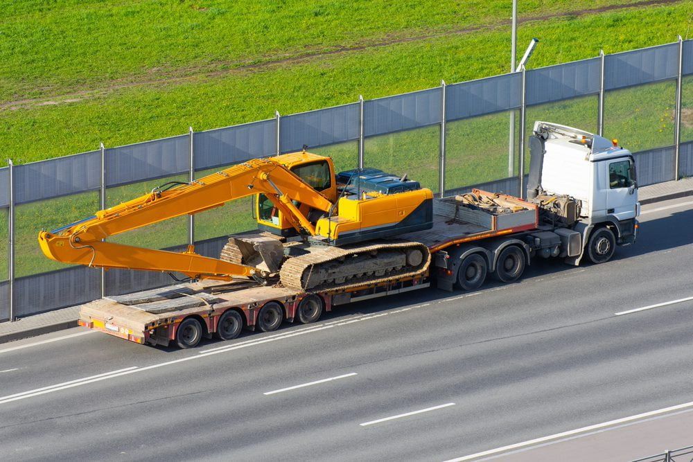 Transporting an excavator on a truck for efficient and reliable excavation services — Stan Davies Excavations in Newcastle, NSW