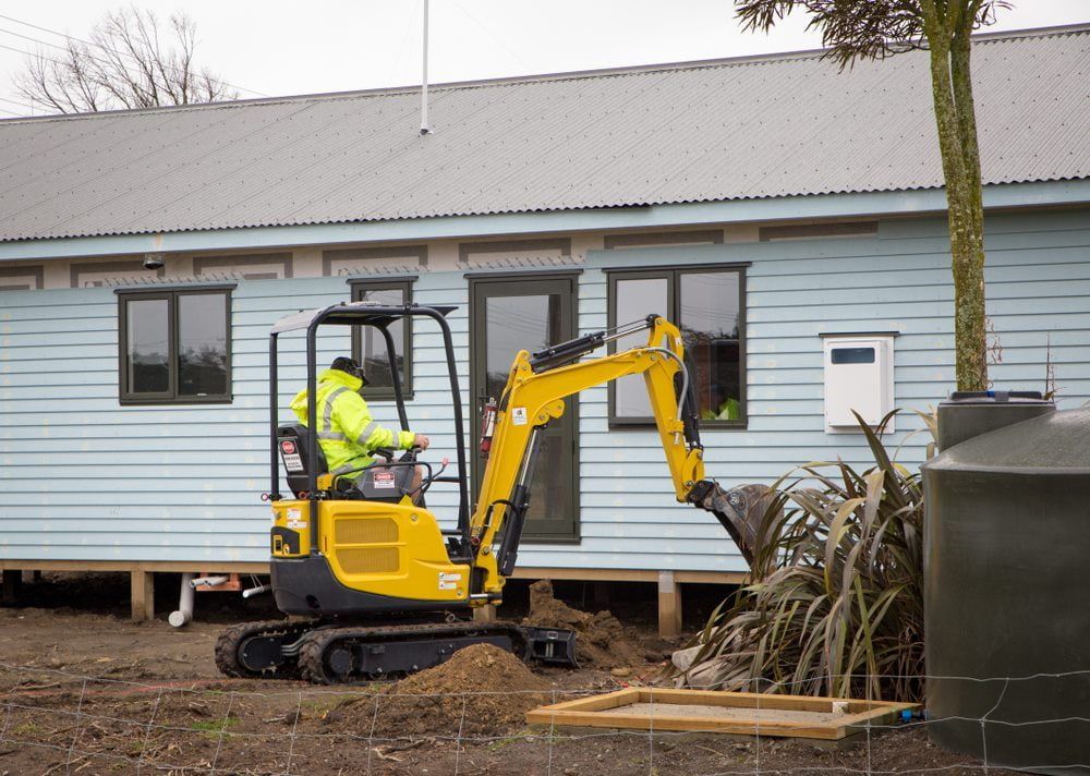 Man operating a small excavator for residential excavation work — Stan Davies Excavations in Maitland, NSW
