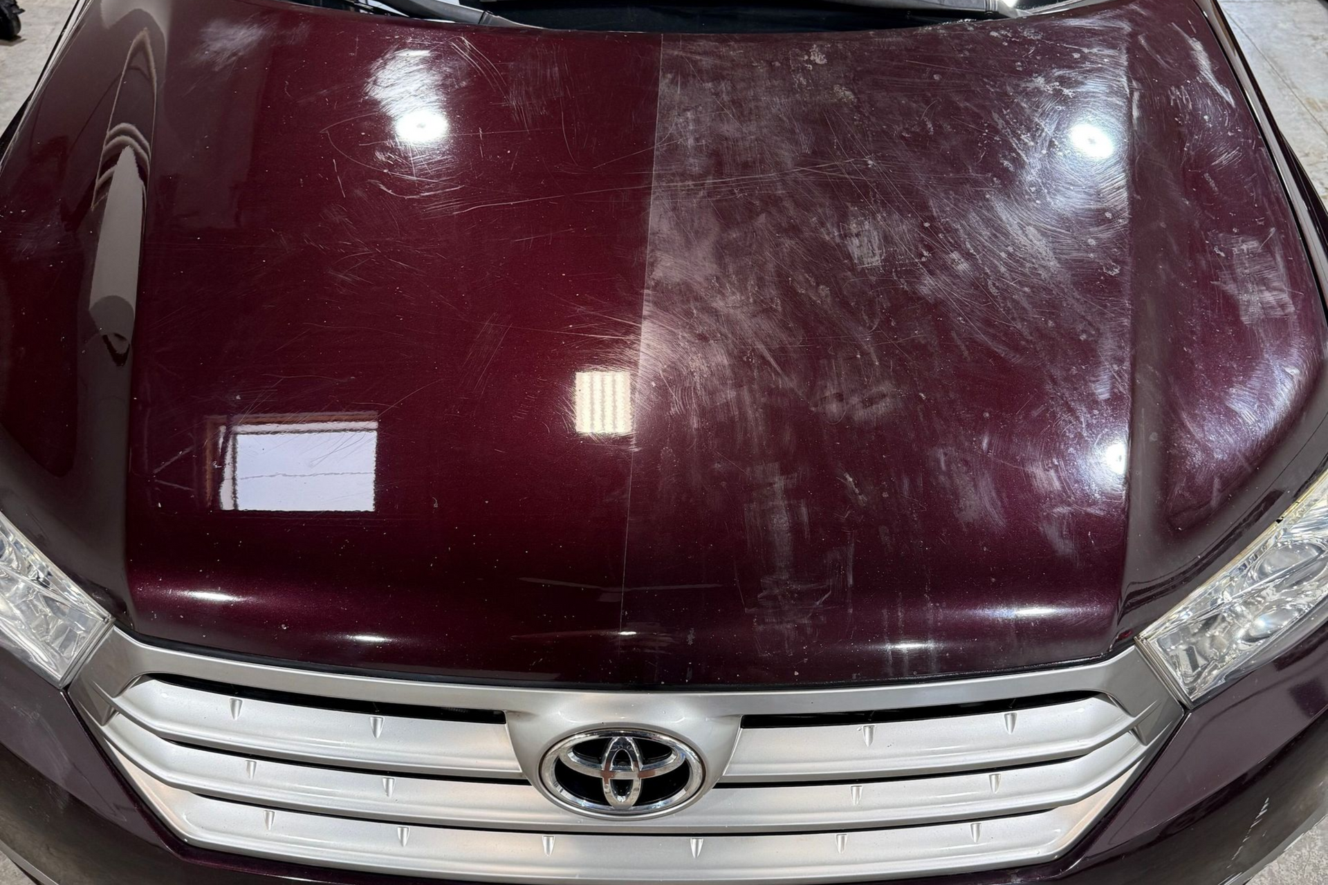 Car hood, half polished, shows scratch removal. The left side is glossy, the right side is scratched.