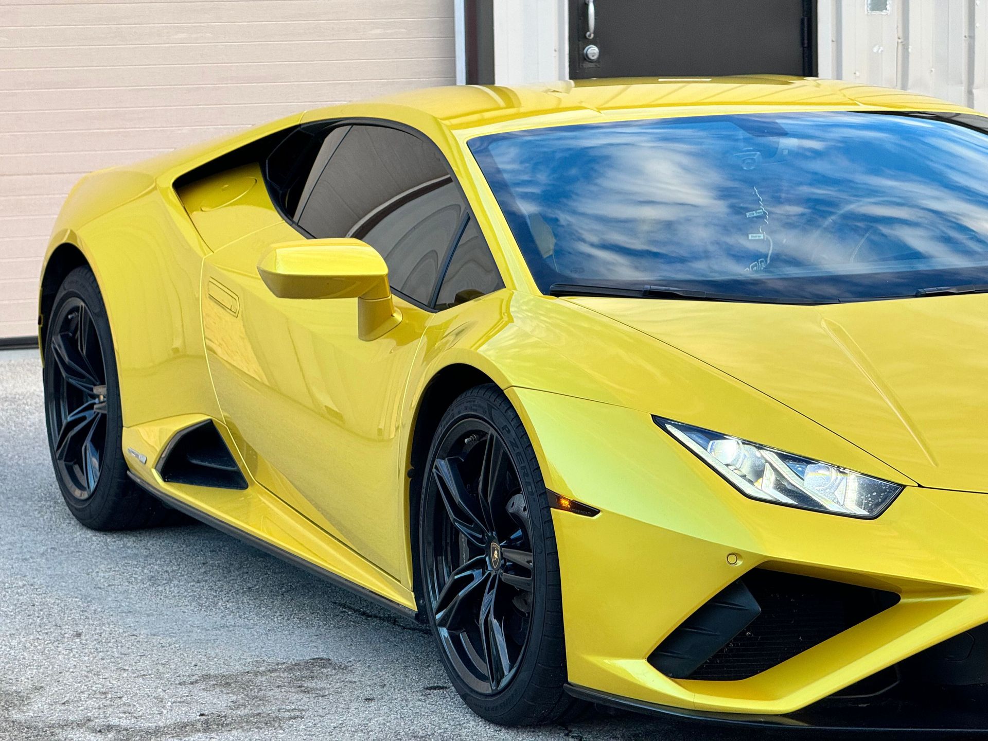 Yellow Lamborghini sports car with black rims.