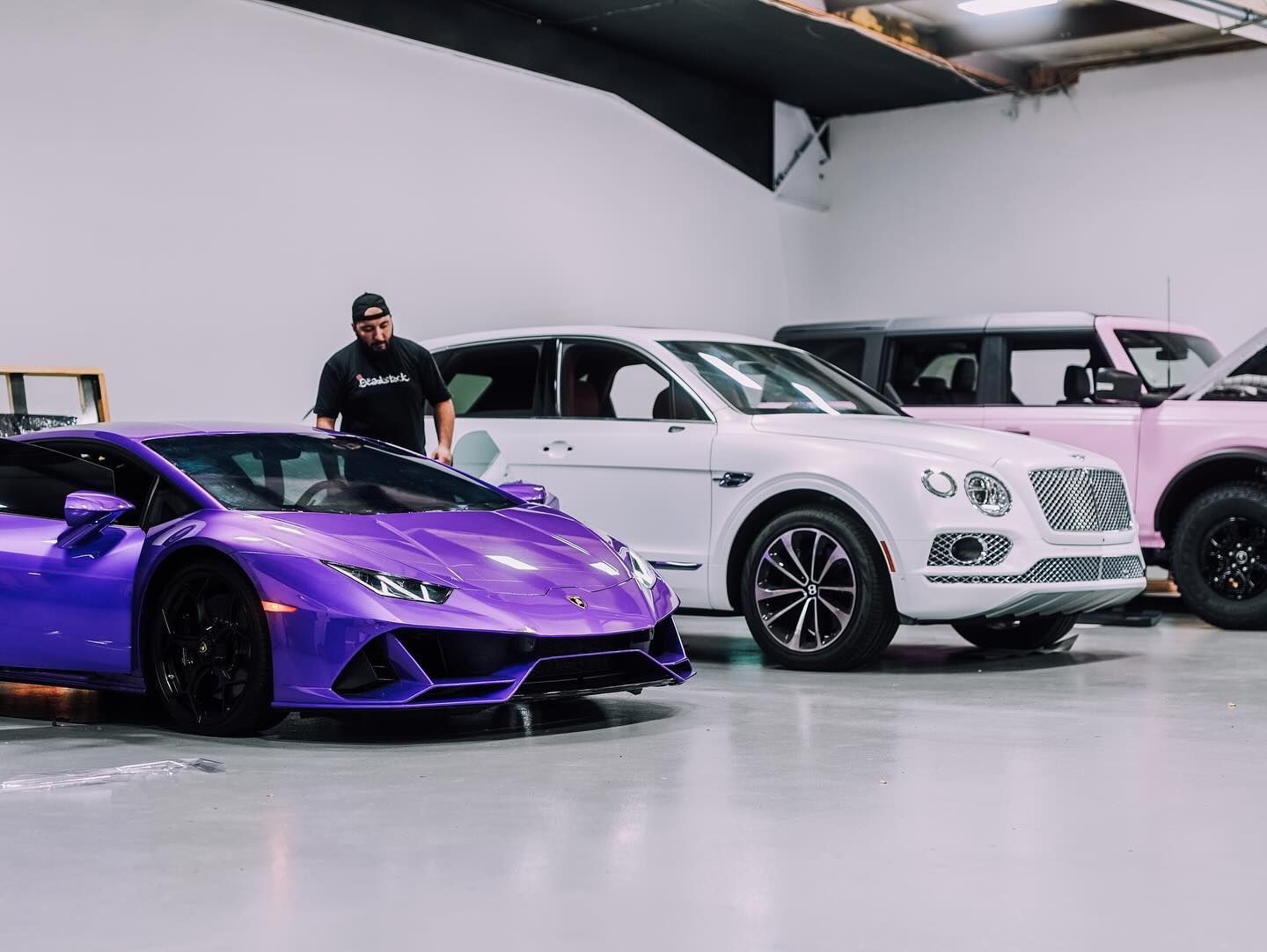 Car hood, half polished, shows scratch removal. The left side is glossy, the right side is scratched.
