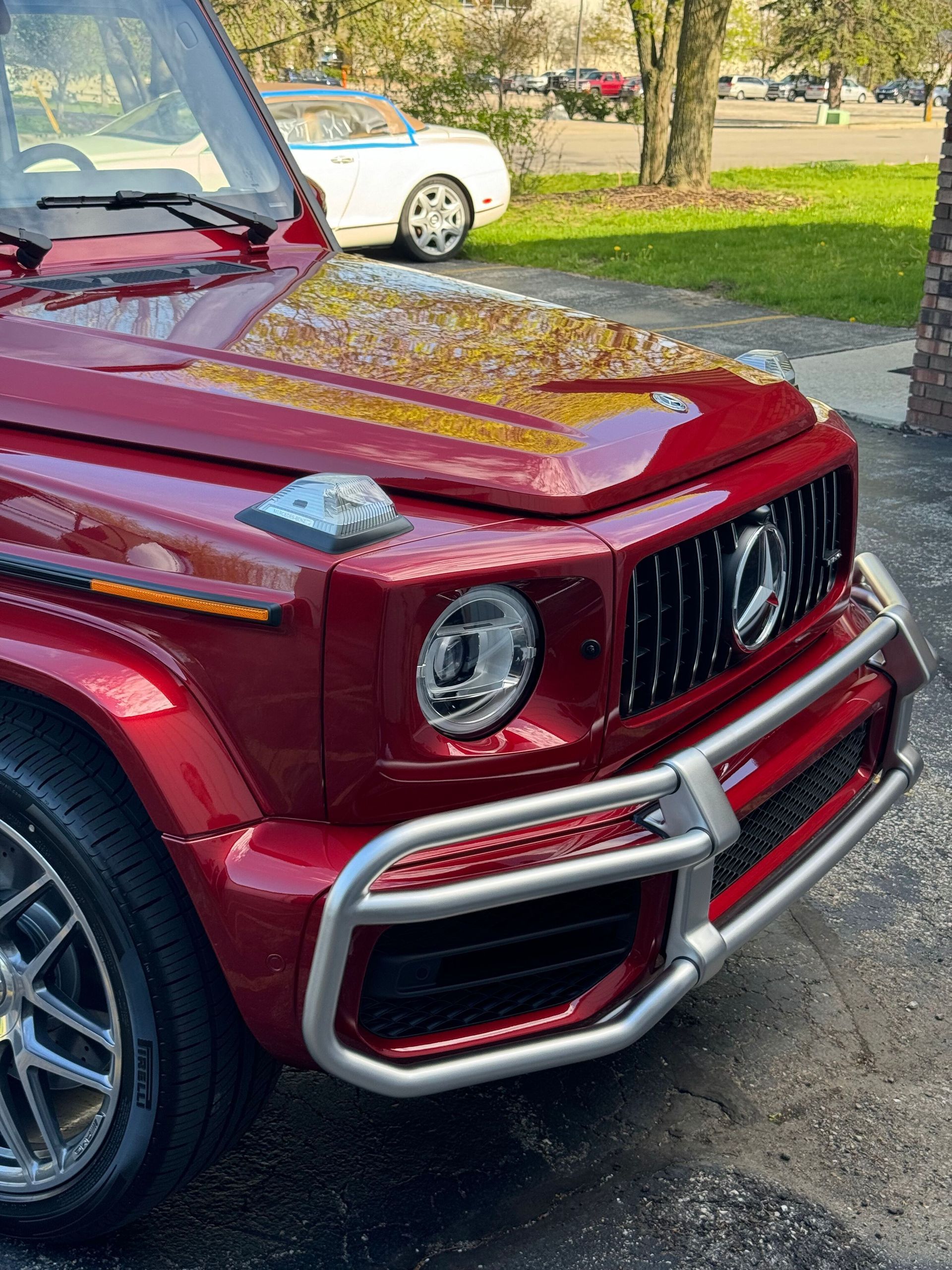 Black Audi e-tron GT parked on a concrete lot in front of commercial buildings, overcast sky.