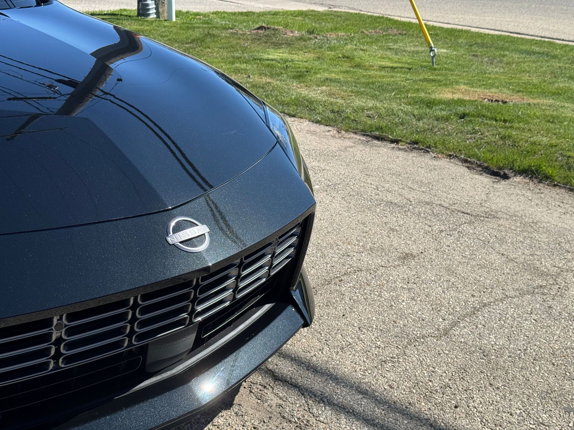 Red Mercedes-Benz G-Class SUV with chrome accents; parked outside, sunny day.