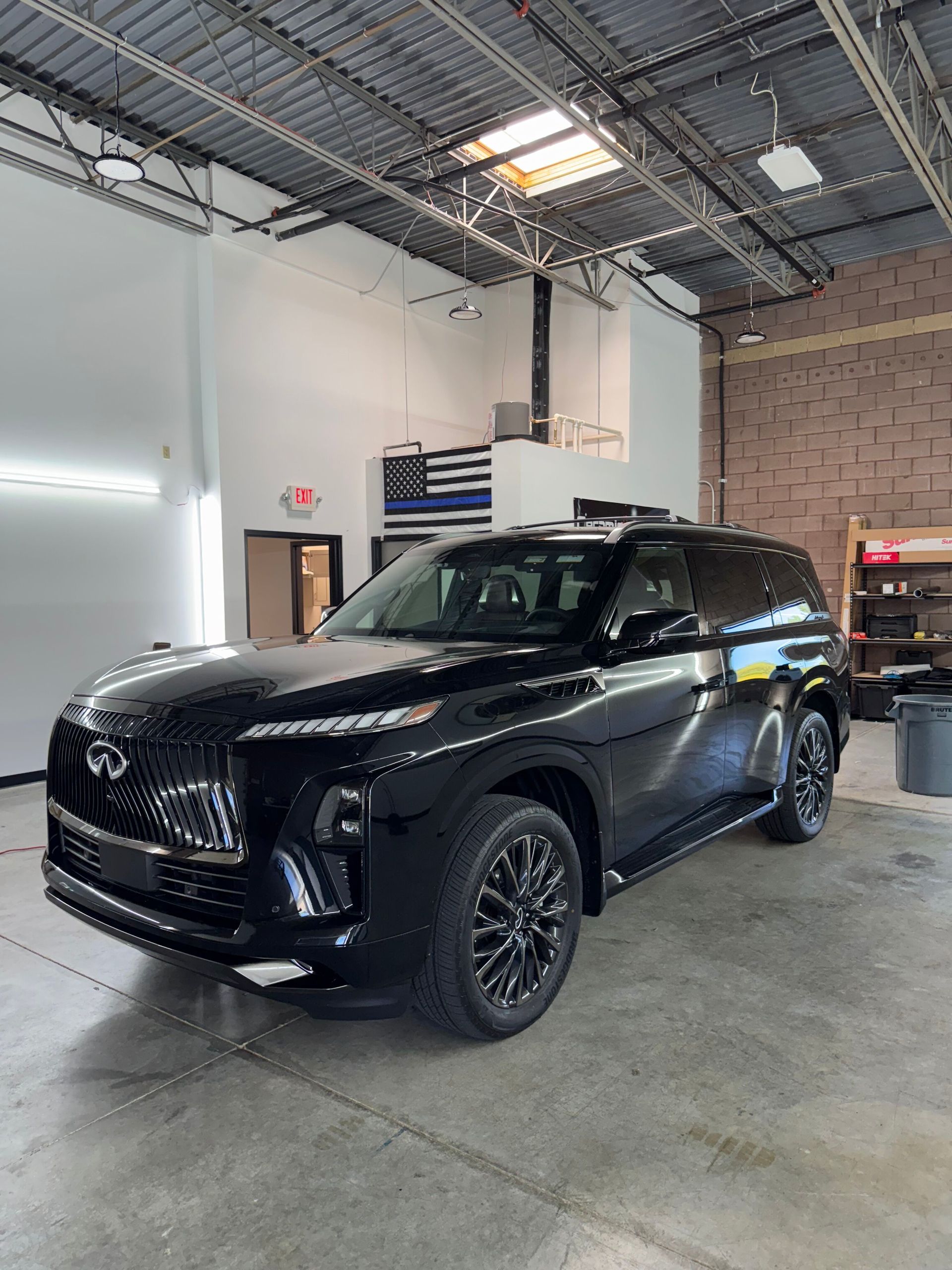 Black SUV parked inside a garage.