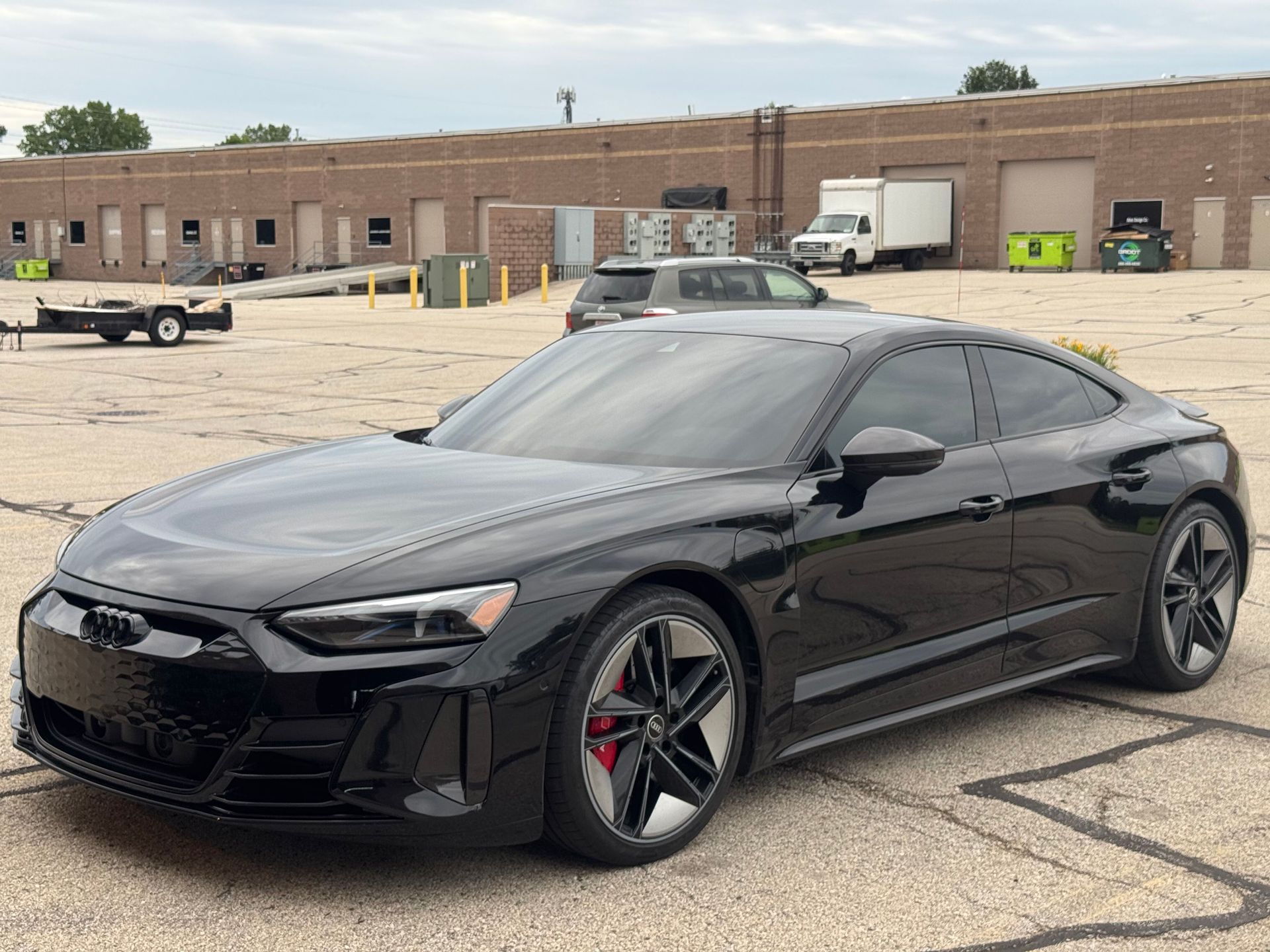 Yellow Lamborghini sports car parked in front of a white building.