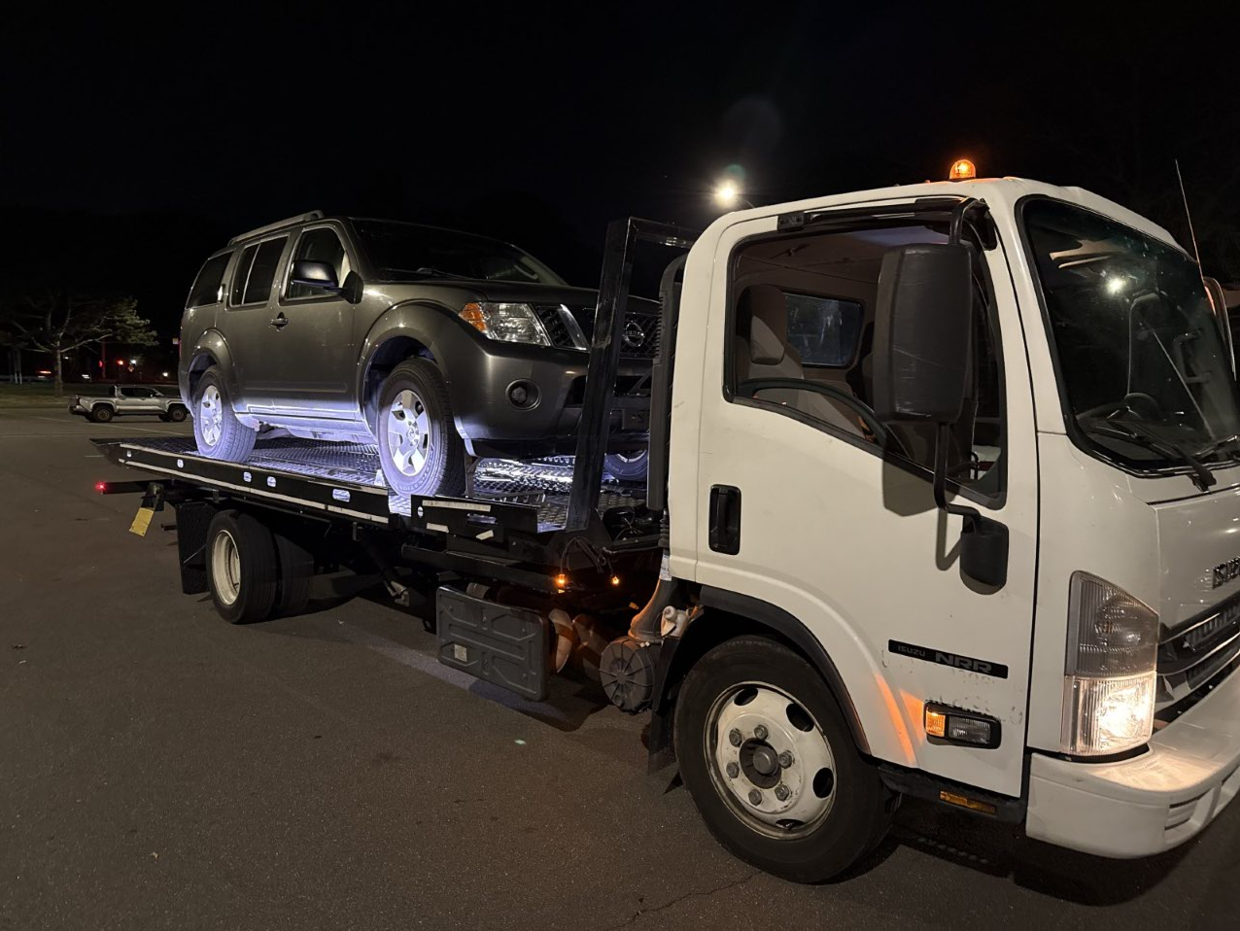 SUV loaded on flatbed and ready for travel