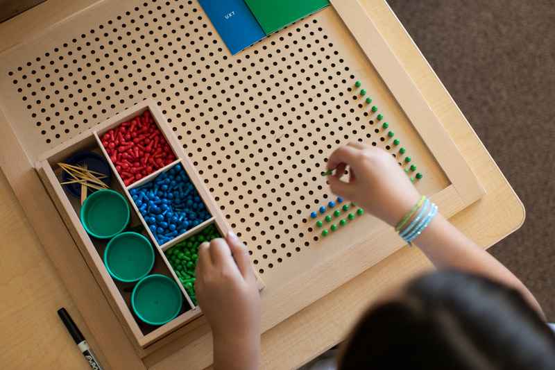 Child working with a Montessori math material