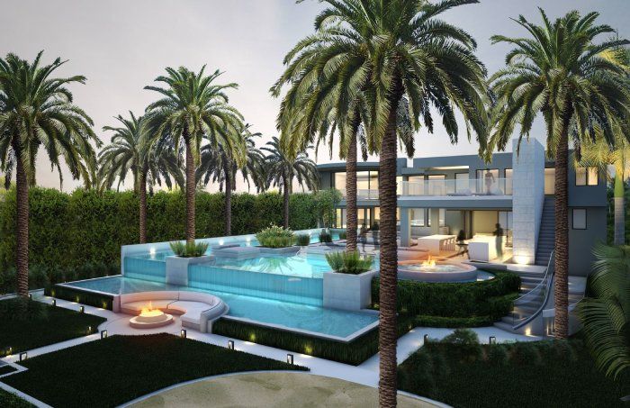 A large house with a swimming pool surrounded by palm trees