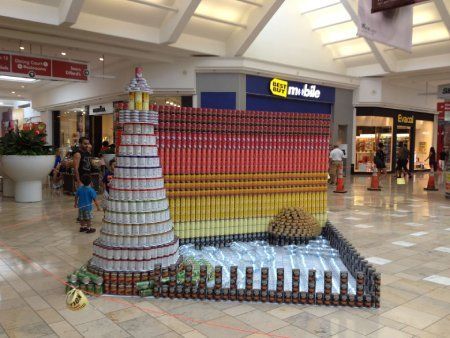 A lighthouse made out of cans in a mall.