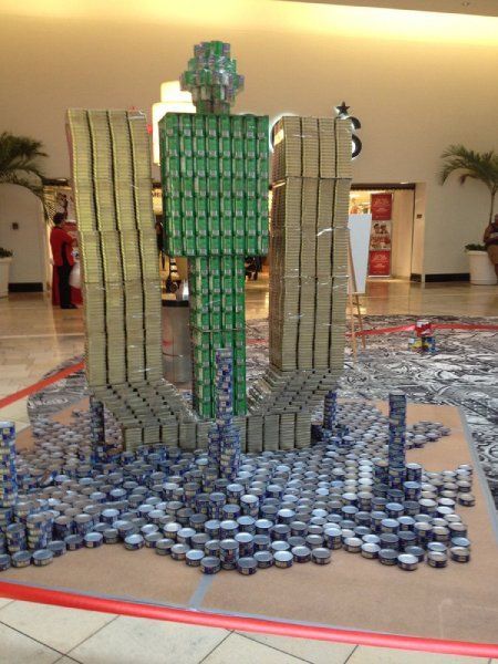 A sculpture of a man made out of cans of soda