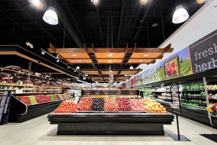 A grocery store with a sign that says fresh herbs