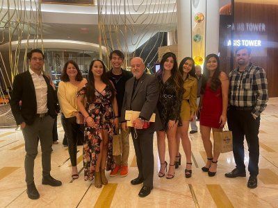 A group of people are posing for a picture in a hotel lobby.