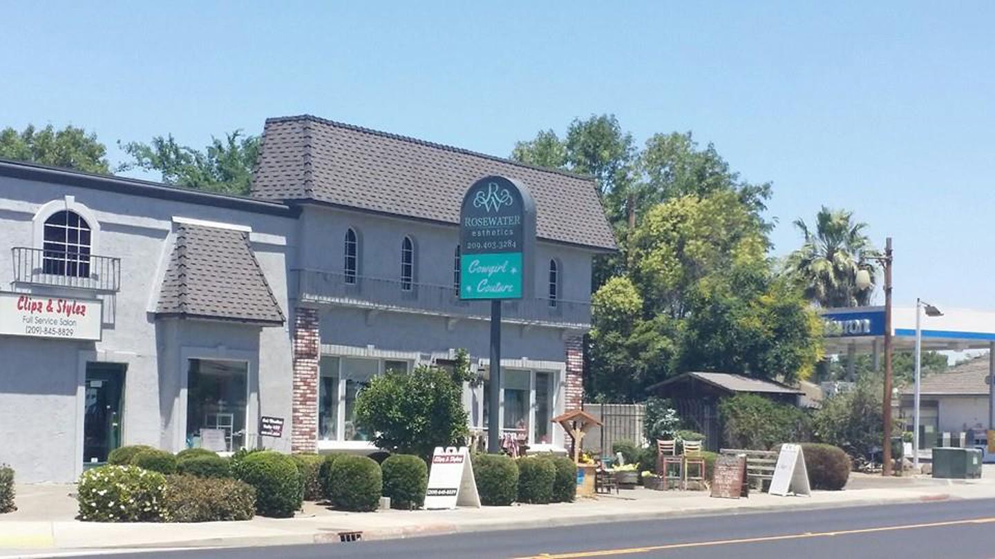A large building with a green sign in front of it