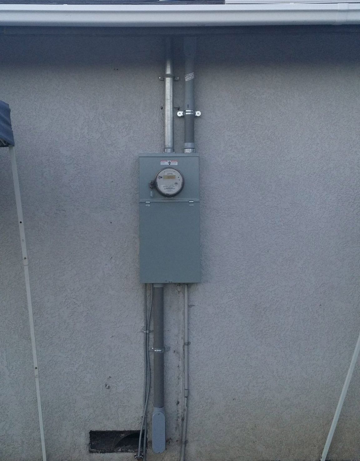 A meter is mounted on the side of a house