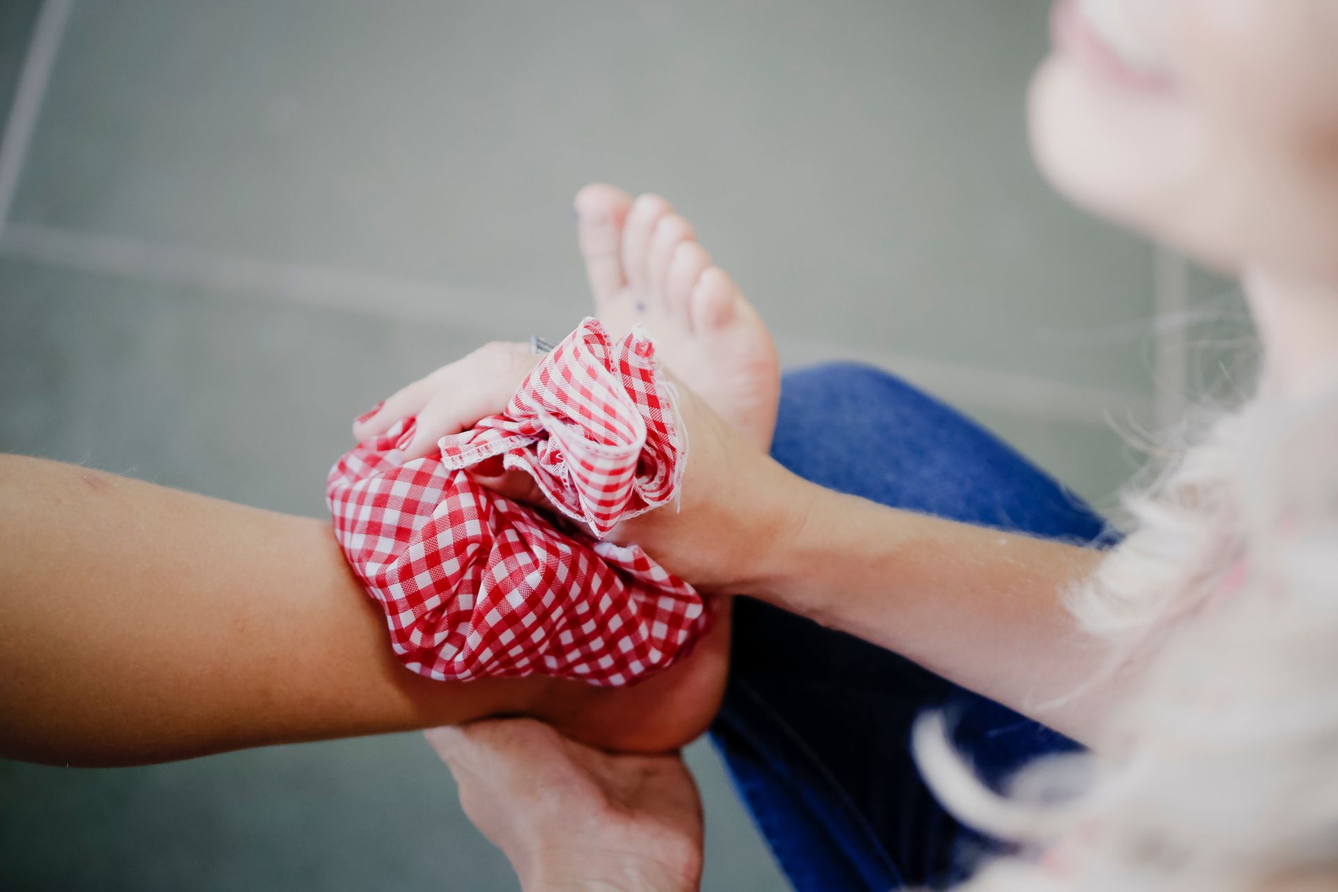 a person has a red and white checkered bag on their foot