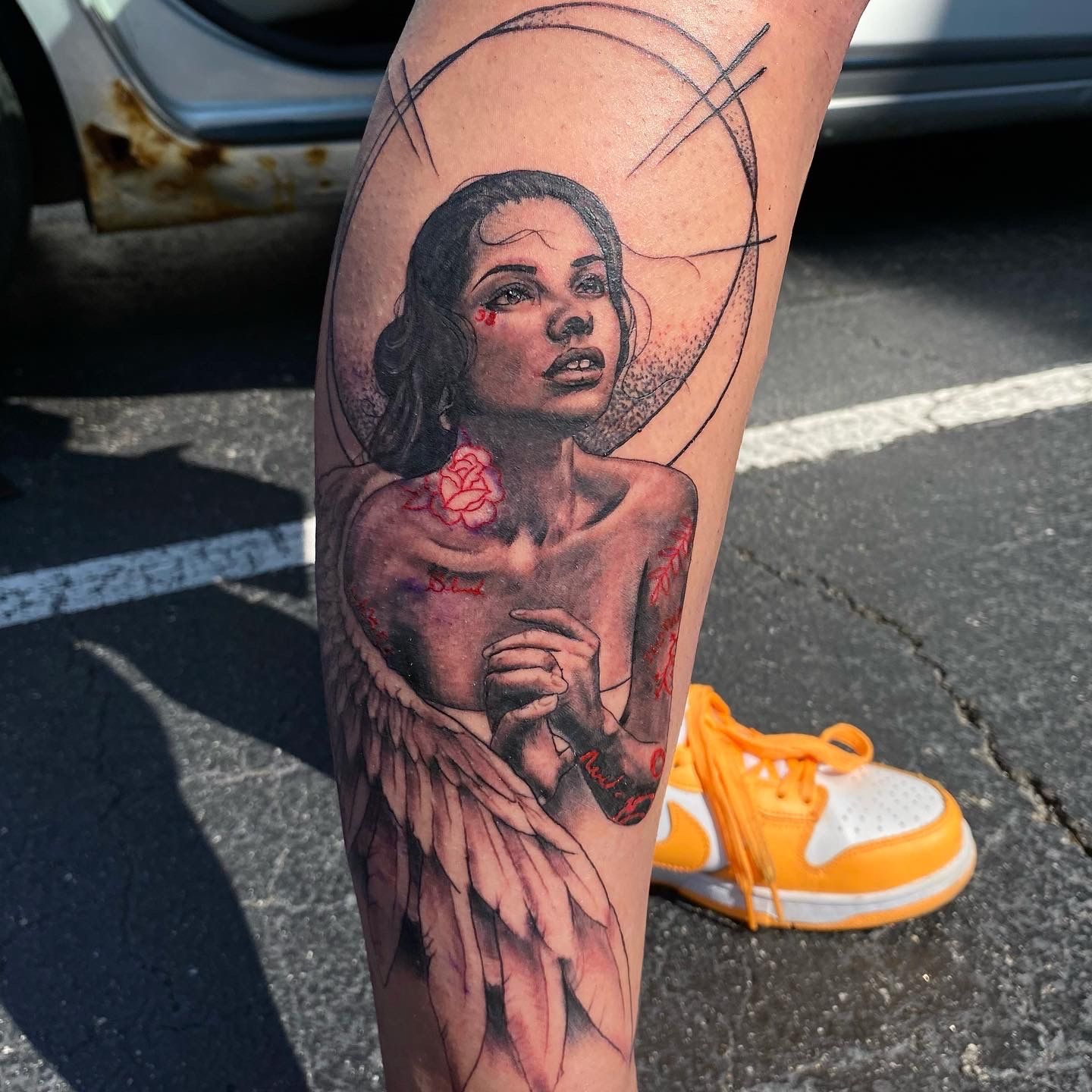 Realistic angel tattoo design on leg, created by top tattoo artists in Raleigh NC.