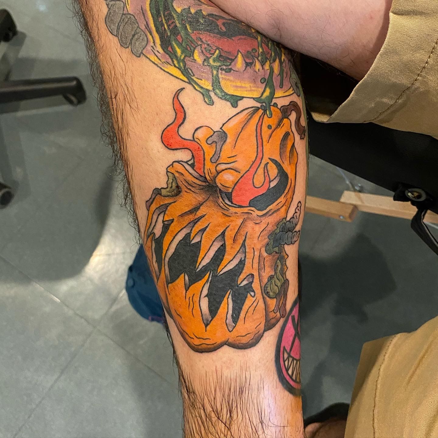 Orange pumpkin tattoo with black outlines, done at a walk-in tattoo shop in Raleigh, NC. Custom tattoo design by local artist