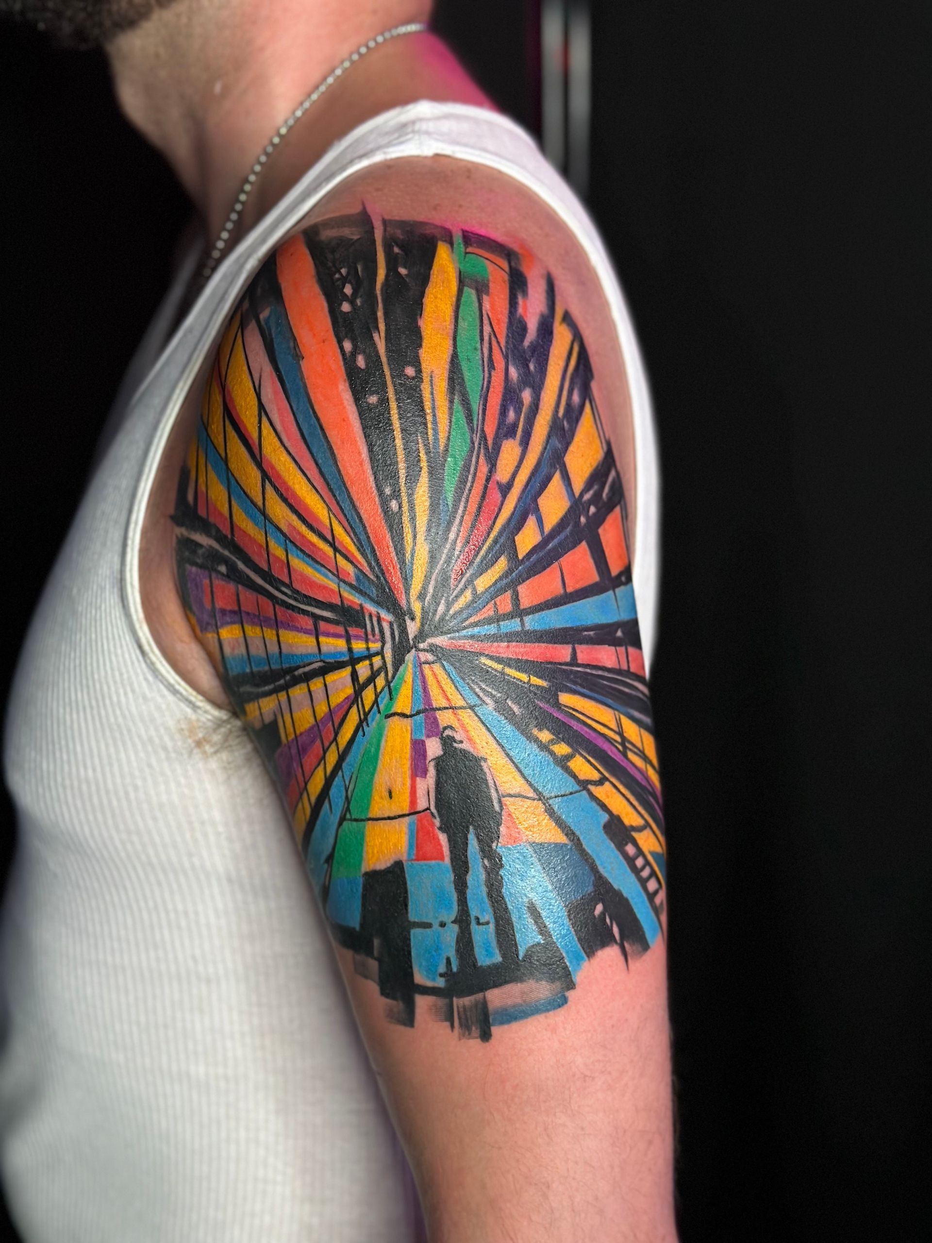 A man has a colorful tattoo on his arm