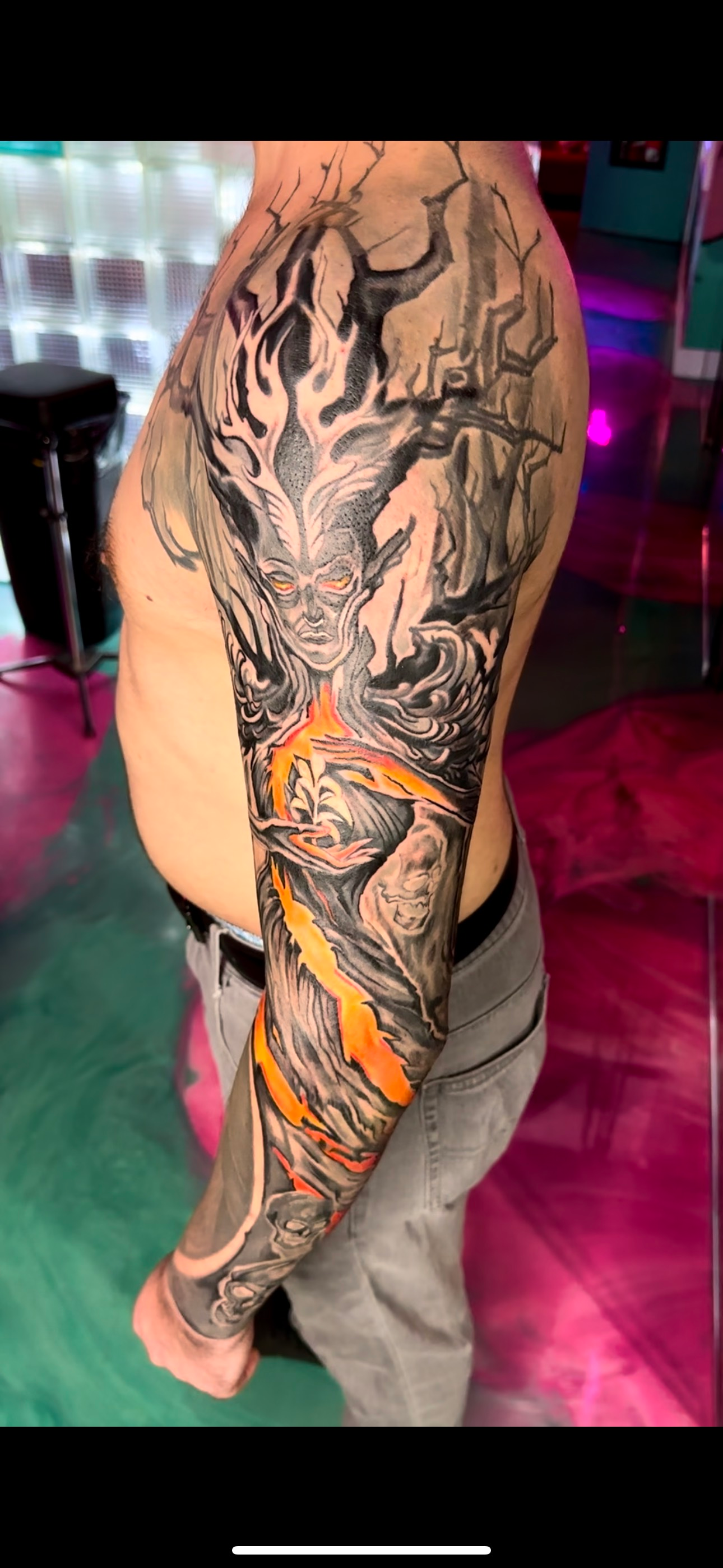 A man with a full sleeve tattoo on his arm.
