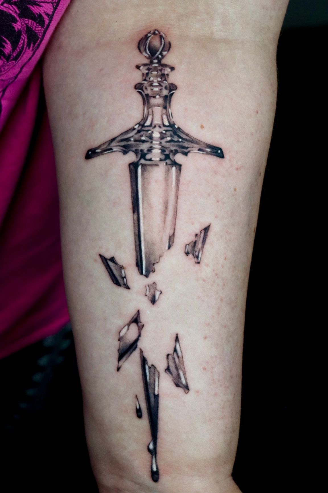 Statue of Liberty forearm tattoo with eagle design, realistic style.