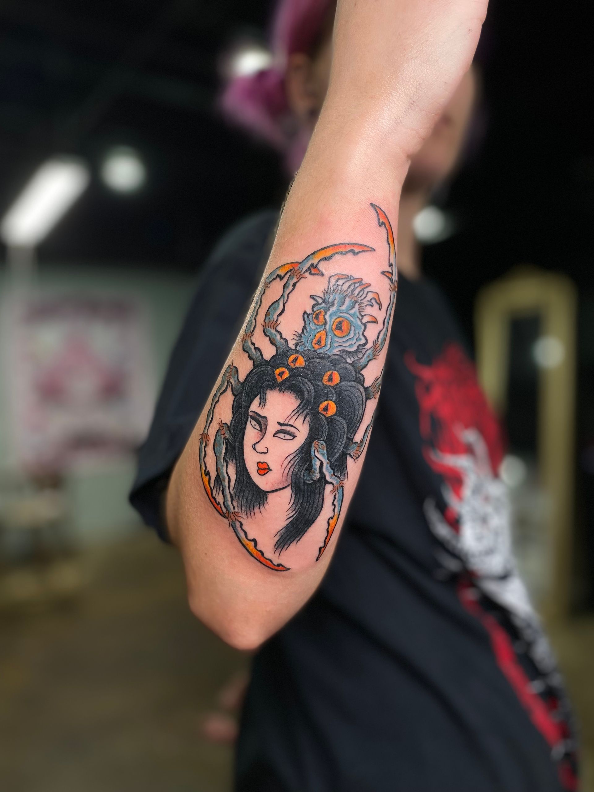 Jorigumo tattoo with a woman's face, designed by top tattoo artists in Raleigh, NC, at a tattoo shop in North Carolina.