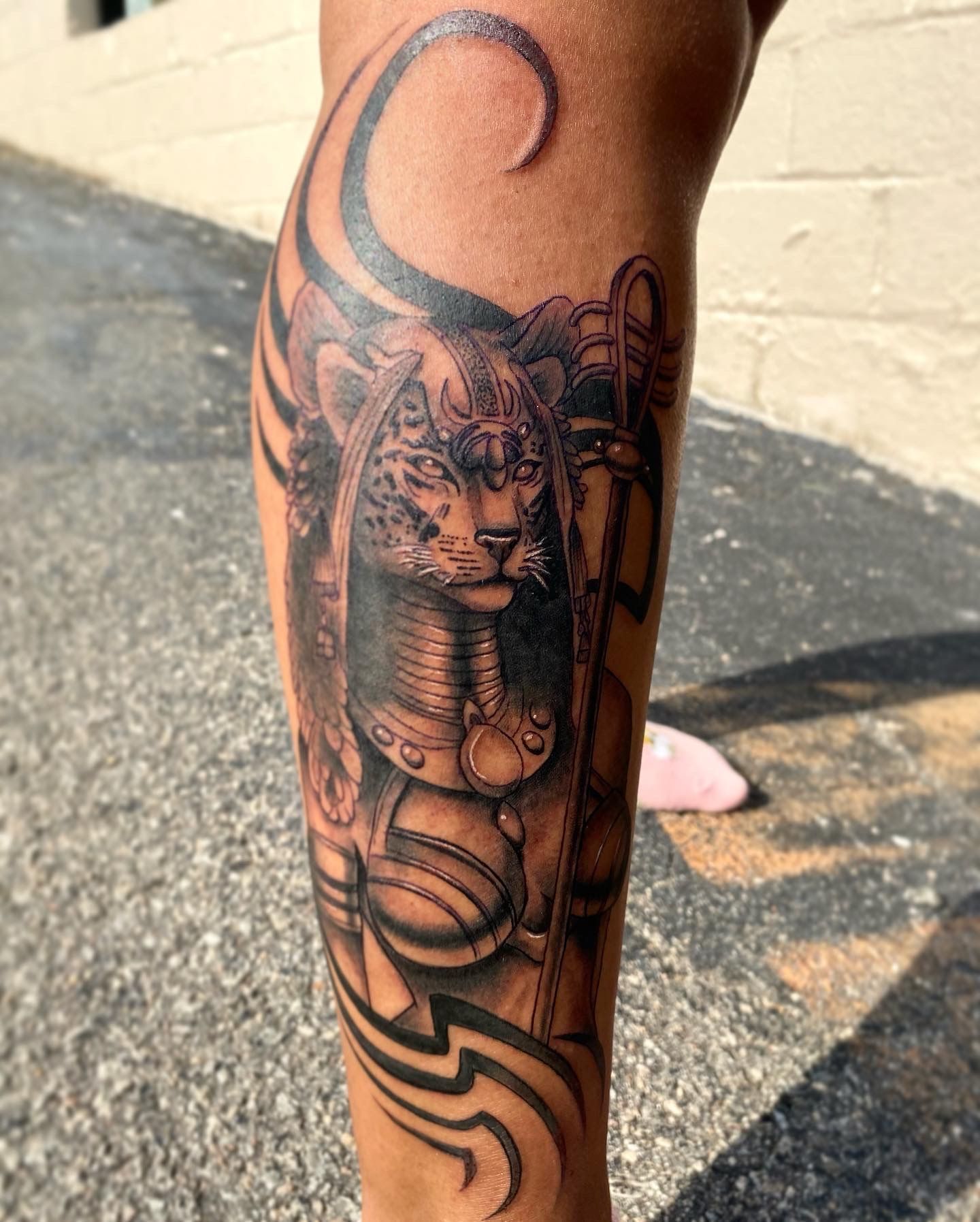 Black and grey Bastet tattoo on leg, created at one of the best tattoo shops in downtown Raleigh NC. Custom forearm tattoo.