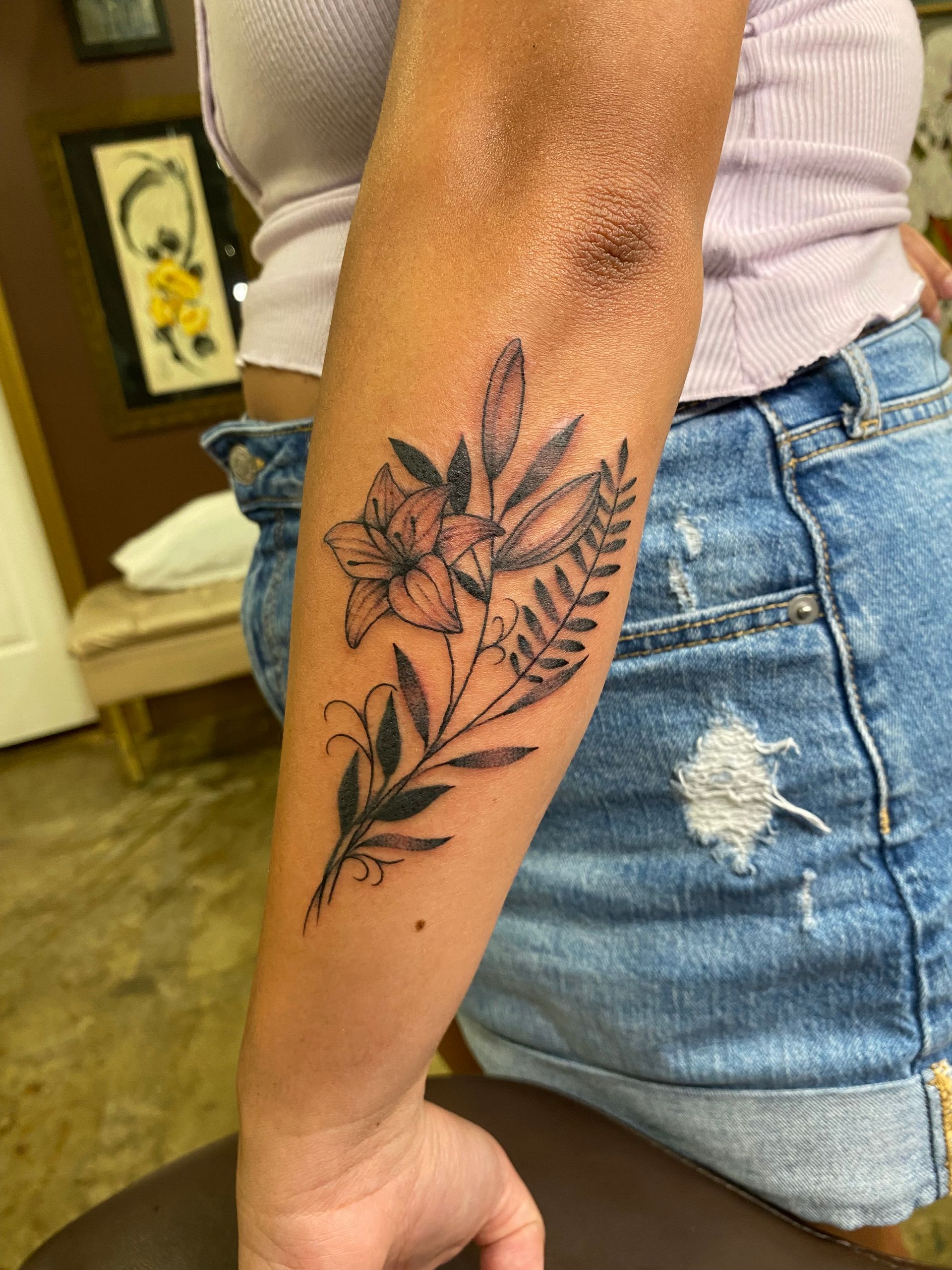 Delicate black flower tattoo on the forearm. Custom design done at one of the best tattoo shops in Raleigh, NC.