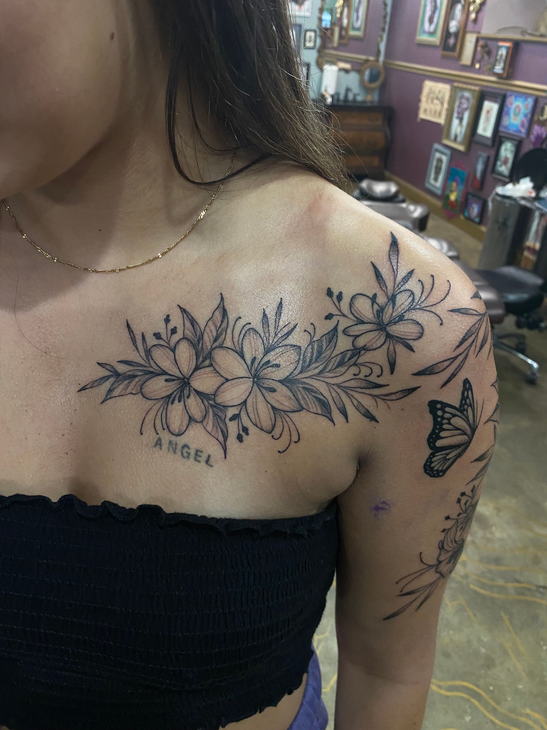 Floral chest tattoo with the word 