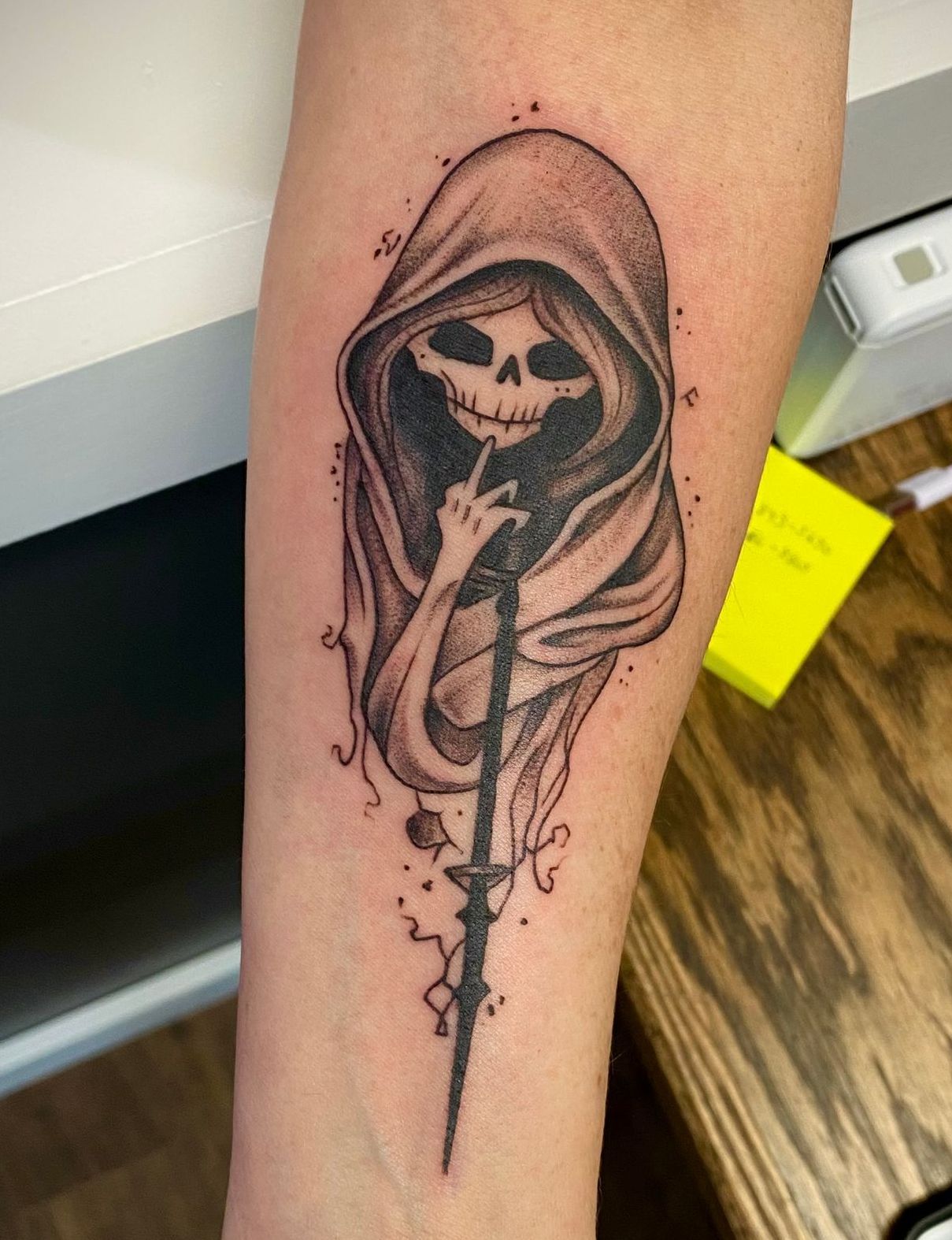 Black and grey Grim Reaper tattoo on the forearm, done at one of the best tattoo shops in Raleigh.