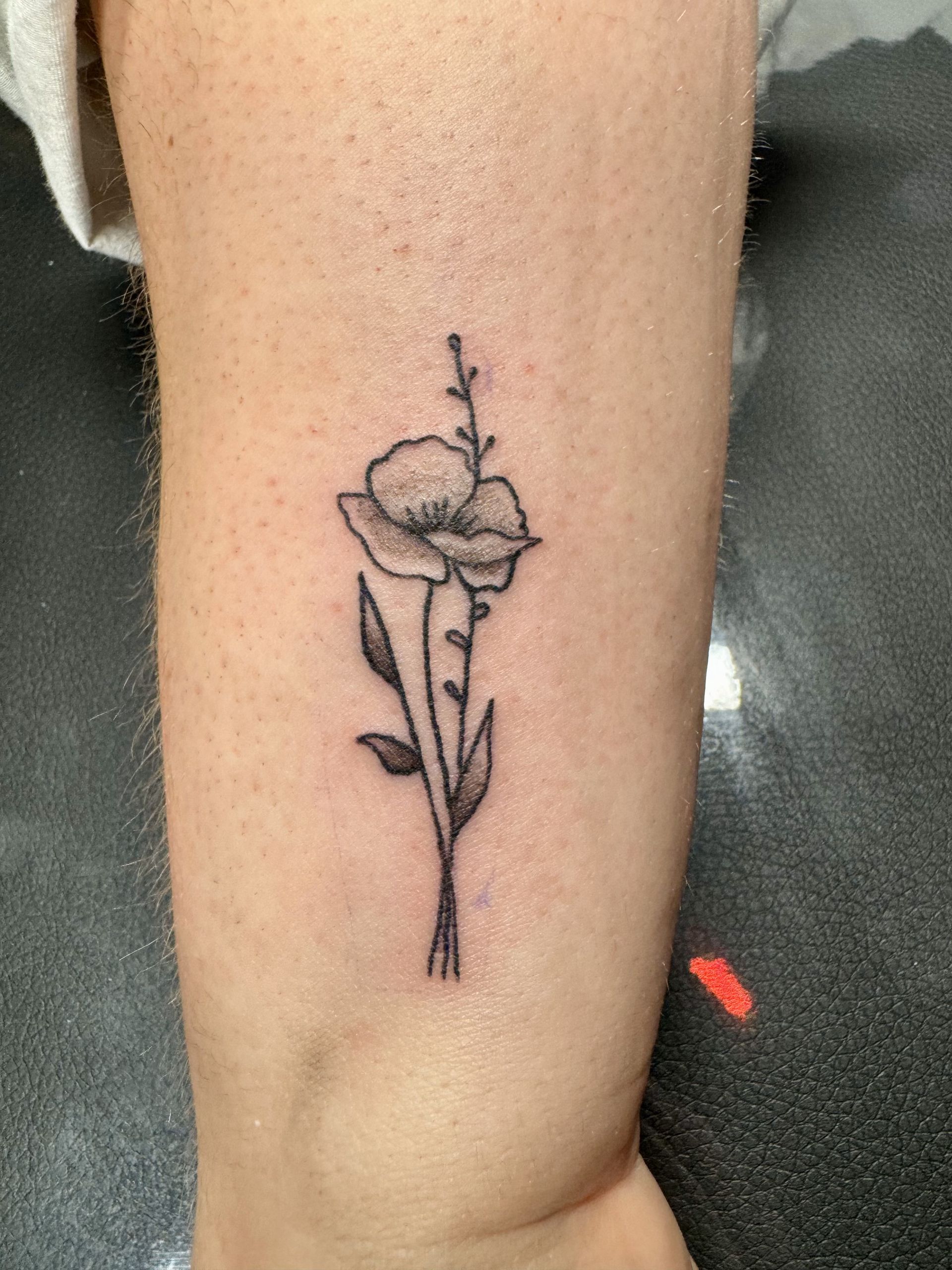 Delicate floral black ink tattoo designed and inked at TEETS X Aether flash tattoo event in Raleigh, NC.