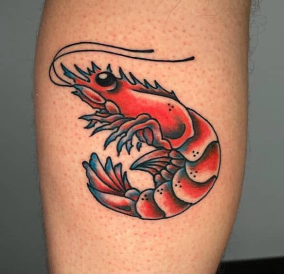 Tattoo of a vibrant red and blue shrimp on a light-skinned leg.