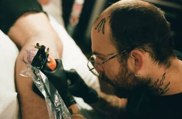 A man with long hair and a beard wearing a red hat