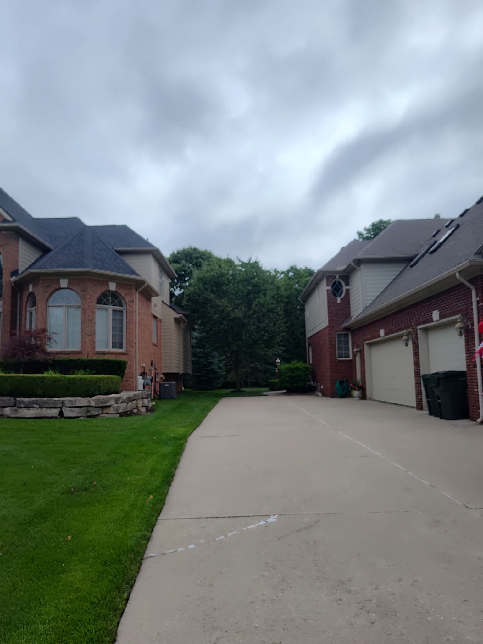 A row of houses with a concrete driveway between them