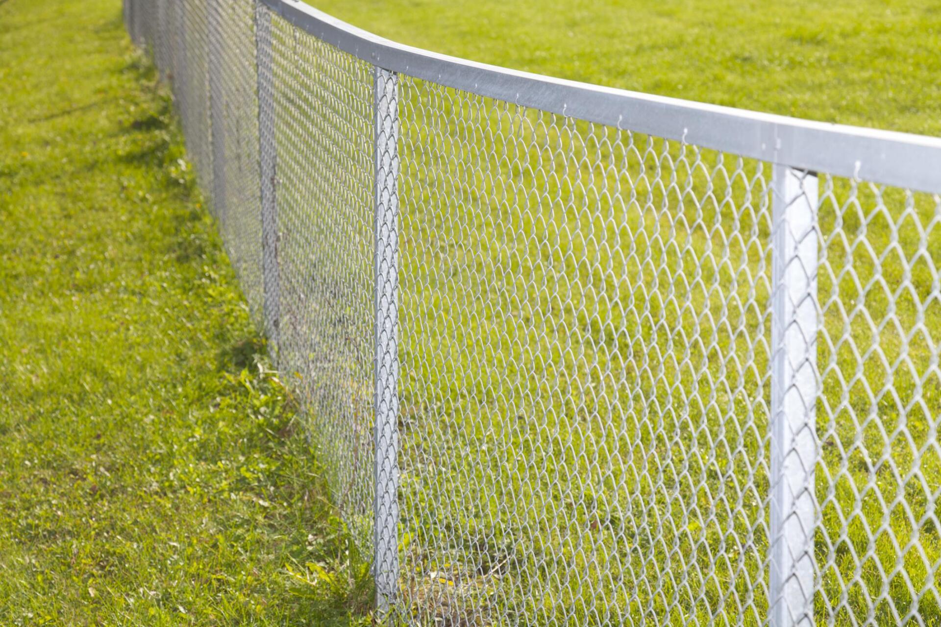 a field with chain link fence
