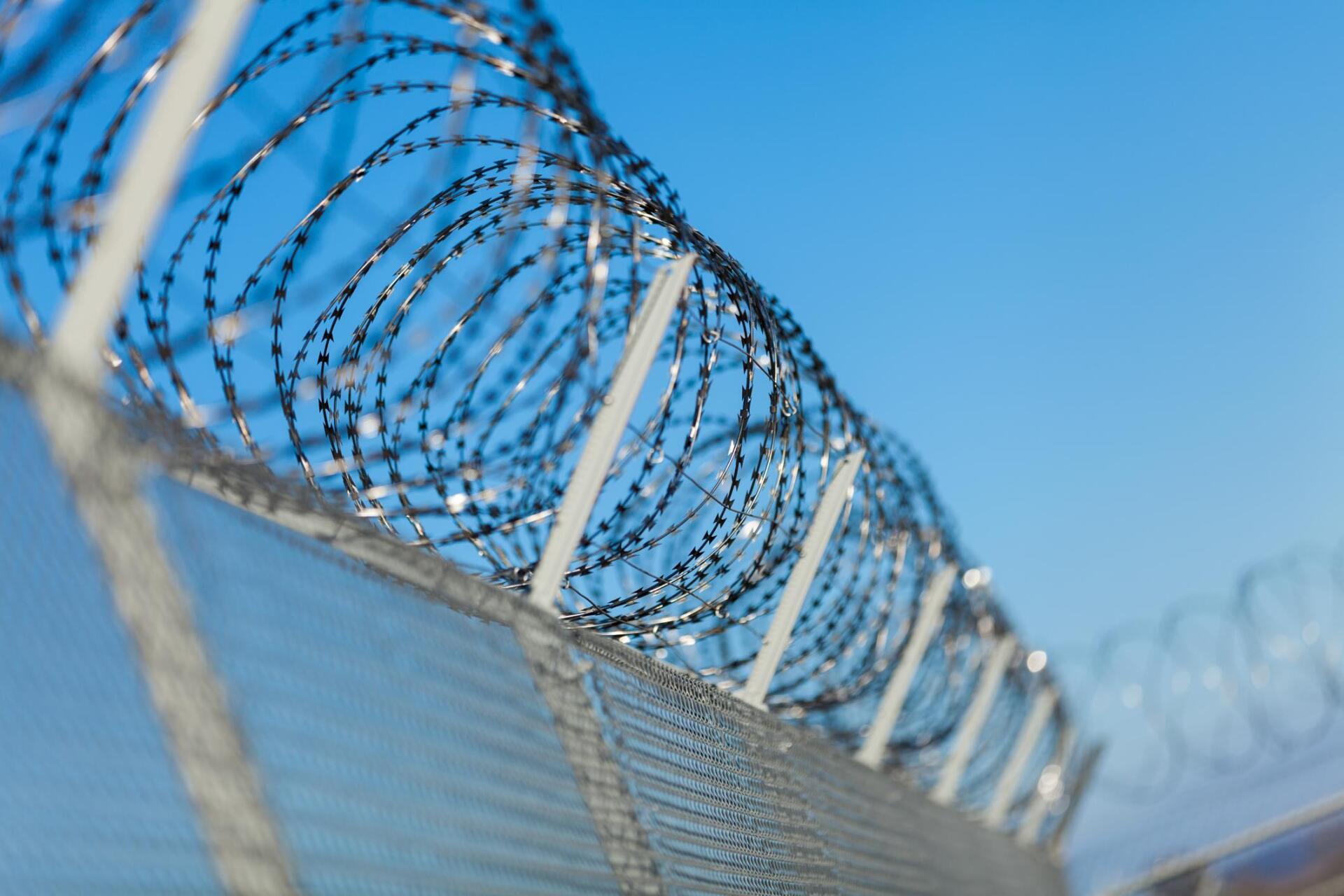 a commercial fence with circular barbed wire