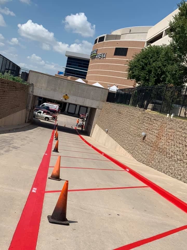 A parking lot with red lines and orange cones