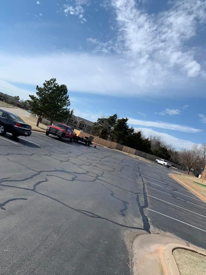 A parking lot with cars parked on the side of the road.