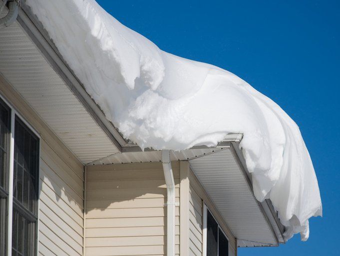 Residential House With Snow On Roof — Muskegon, MI — Schmidt Roofing and Construction